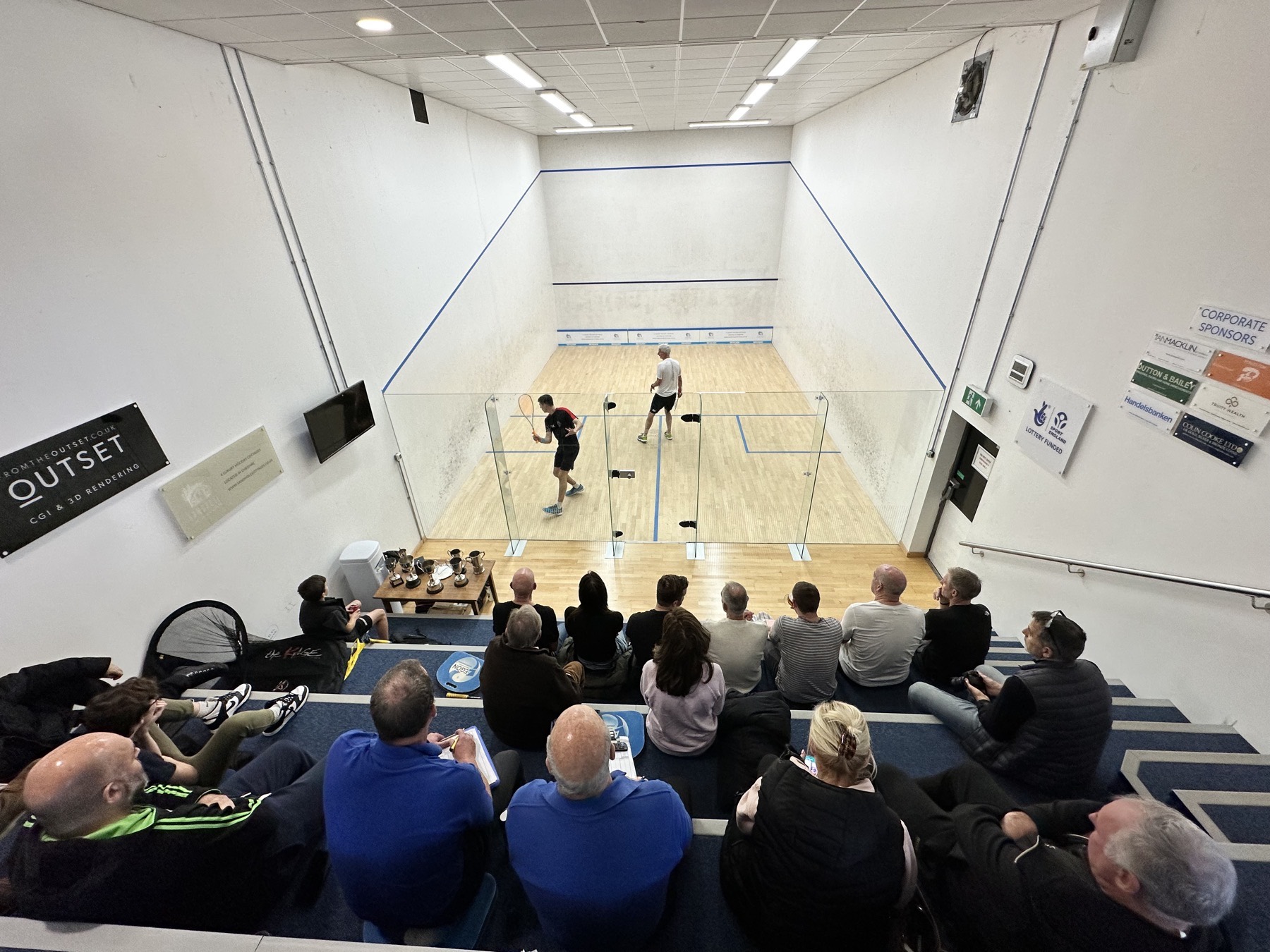 A packed gallery watches a match on the glass-back show court